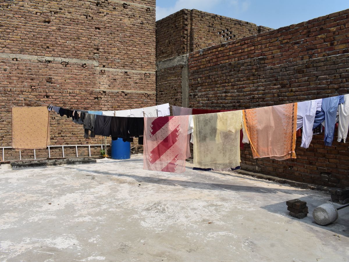 Laundry hanging out to dry on a line under a sunny sky