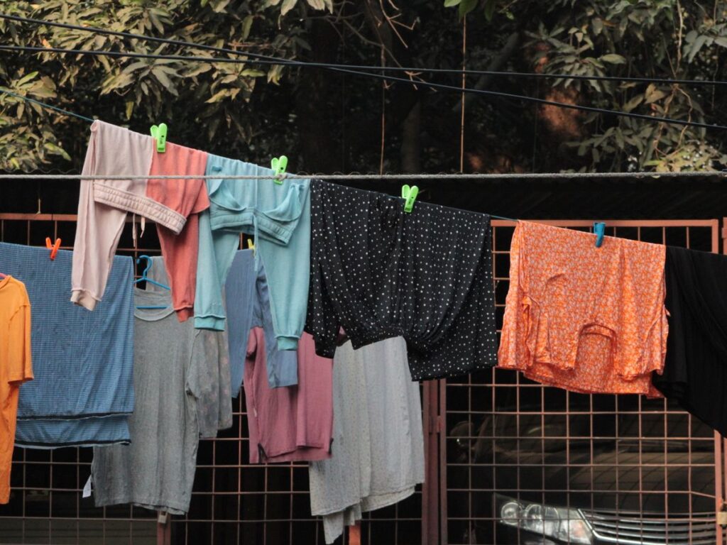 Clothes air drying on an outdoor clothesline in a backyard