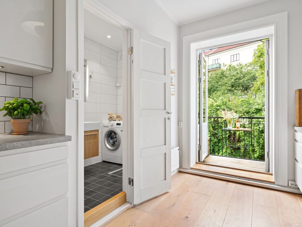 Contemporary apartment kitchen and laundry area in a small space