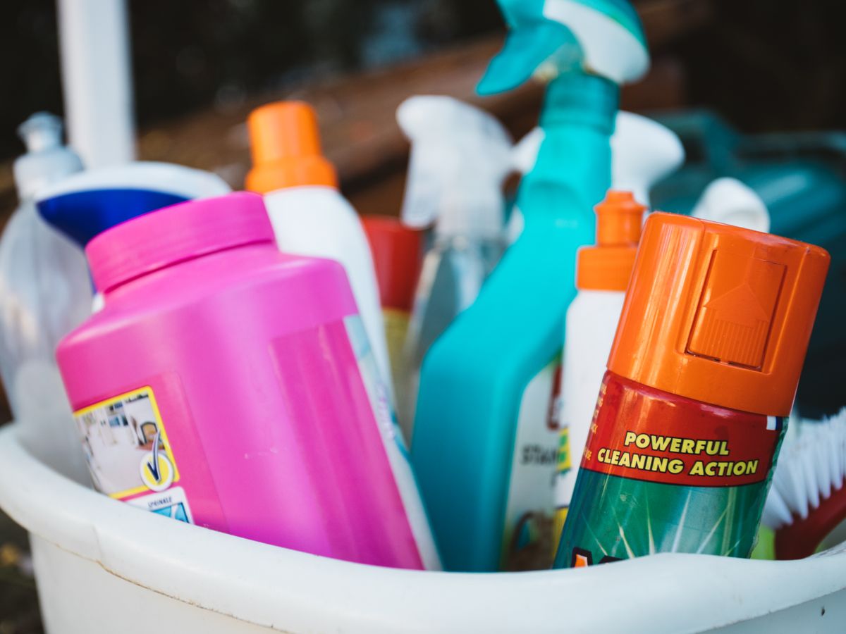Assorted stain removal supplies in a small bucket