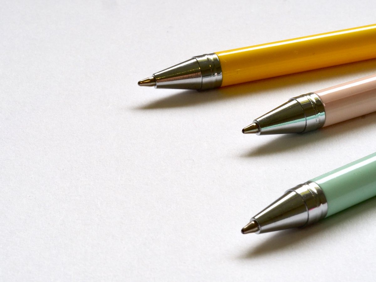 Three ballpoint pens on a white surface
