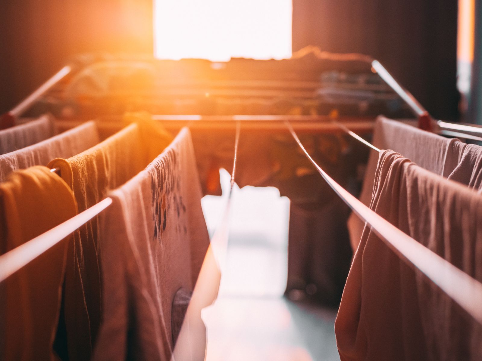 Bed sheets drying indoors in warm light