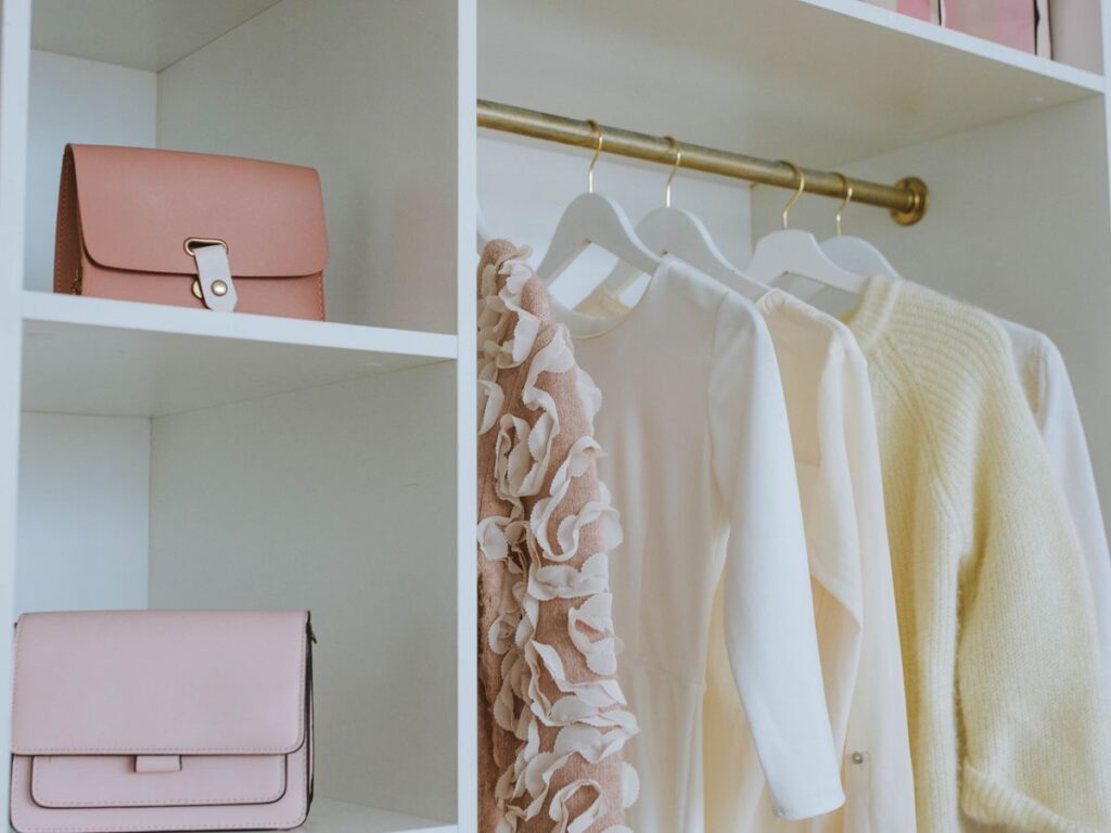 Organized capsule wardrobe closet supporting a capsule laundry routine