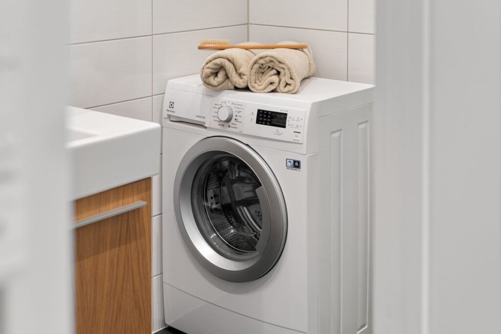 A compact small space washer in a tidy apartment