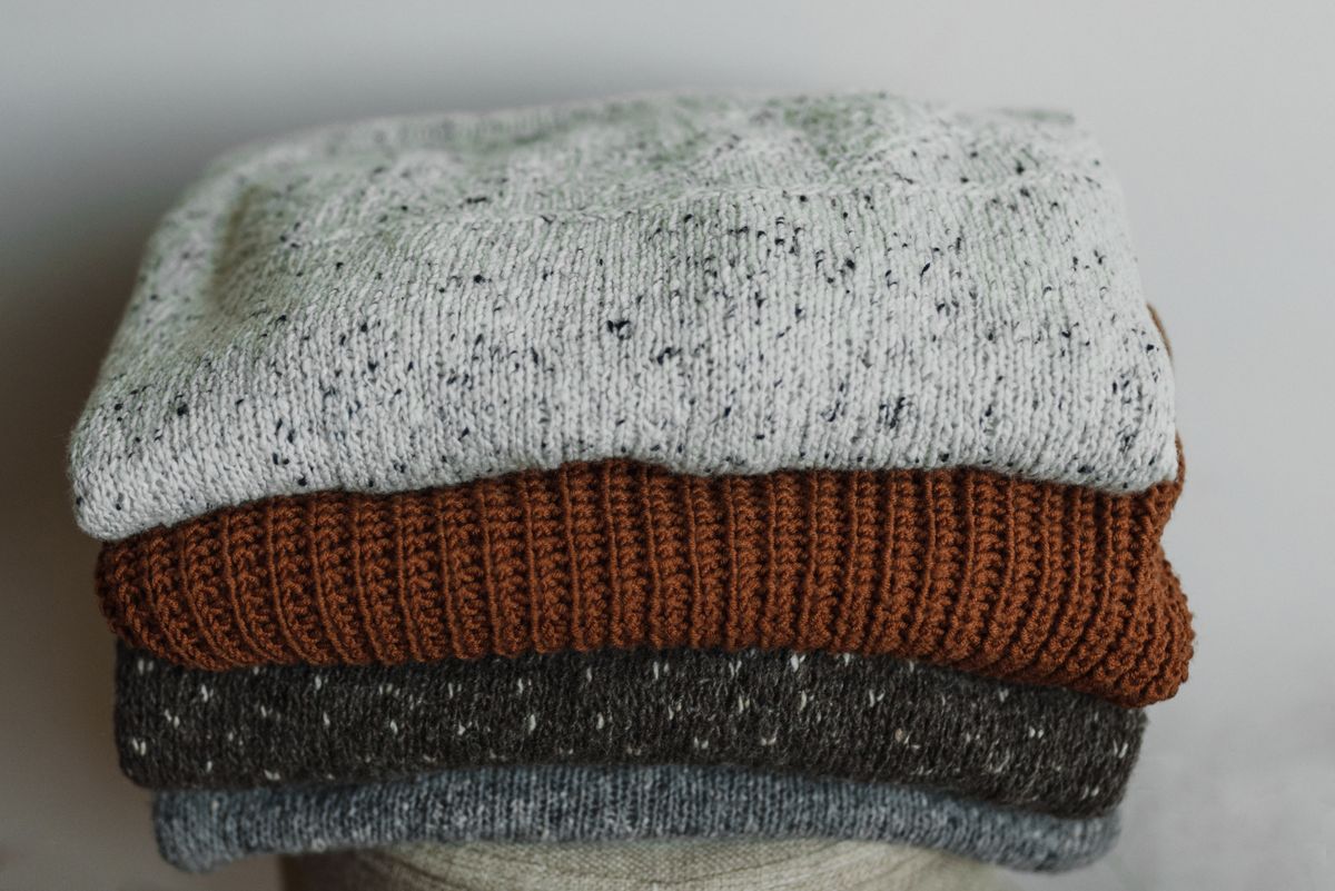 Clean folded knit sweaters ready for seasonal storage