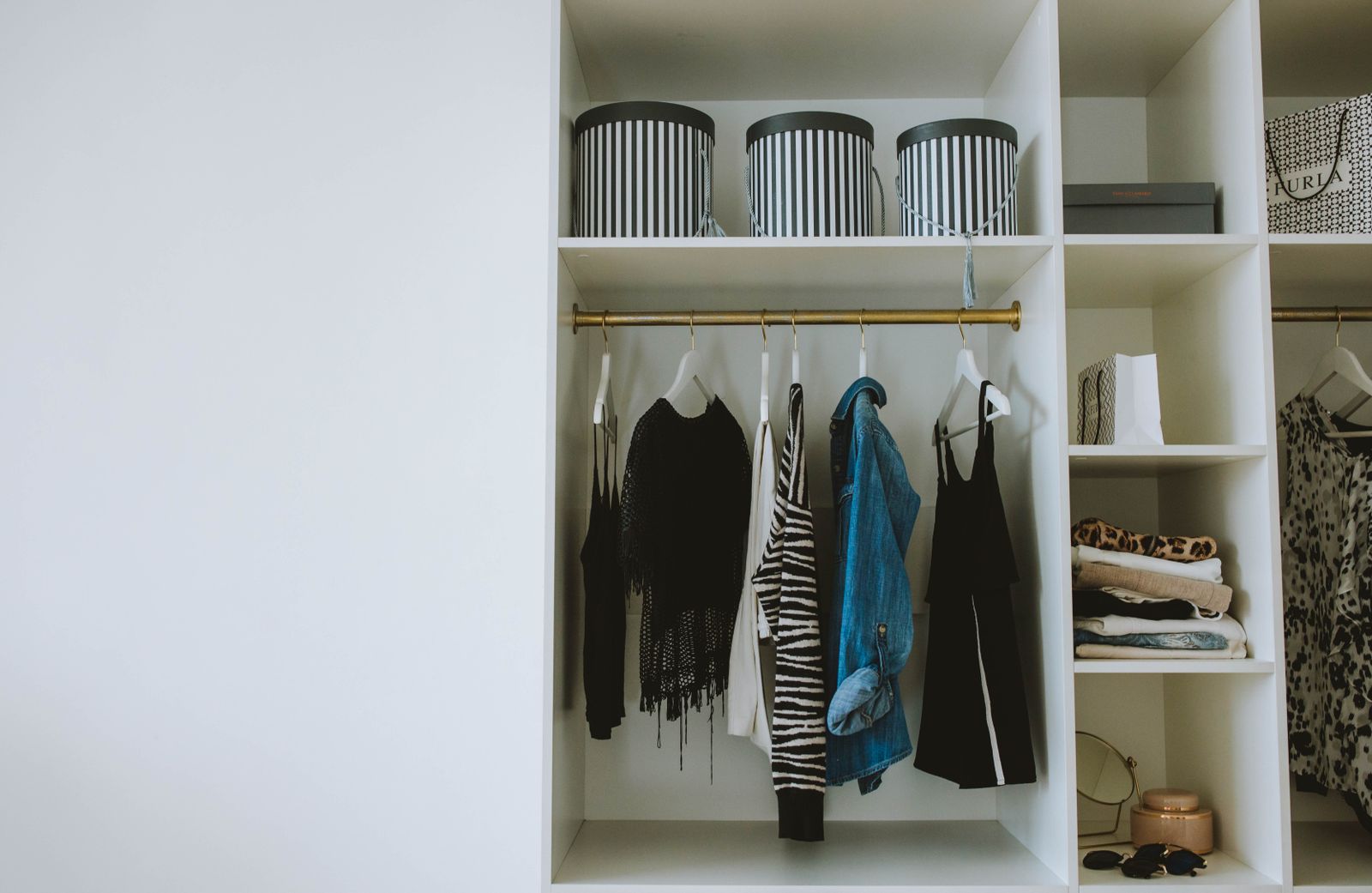 Organized closet with storage boxes on a shelf for keeping vacuum bags flat