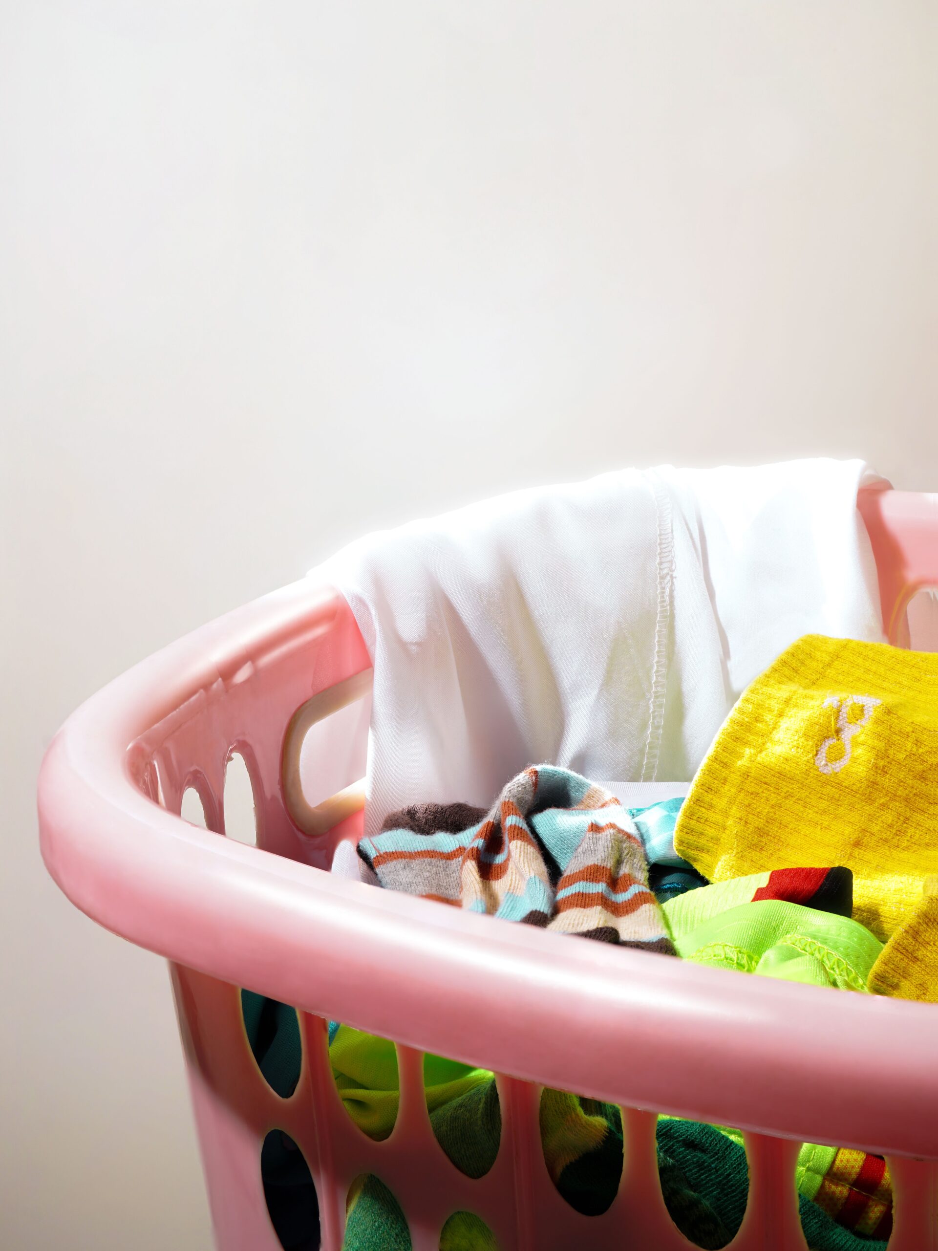 Laundry basket of colorful clothes ready for the dryer