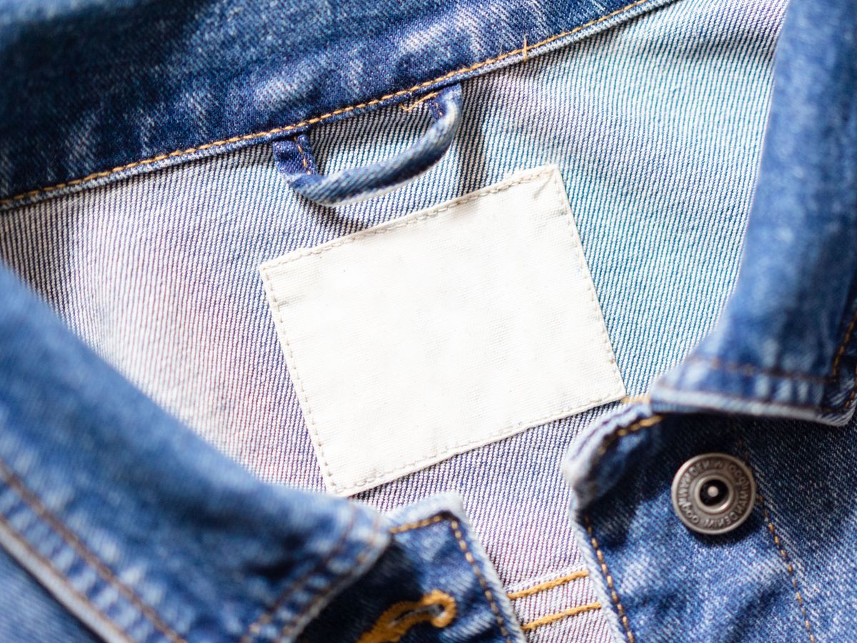 Laundry symbols explained on a denim jacket collar care tag