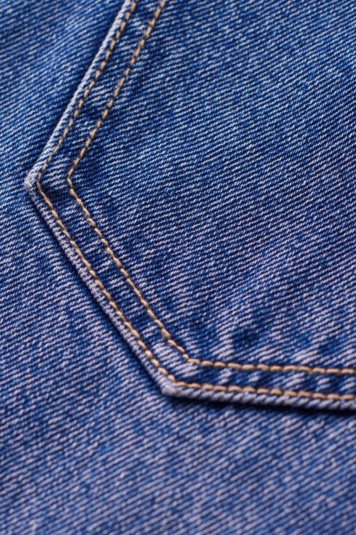 Detail of denim jeans pocket showing wear you get when you care for denim