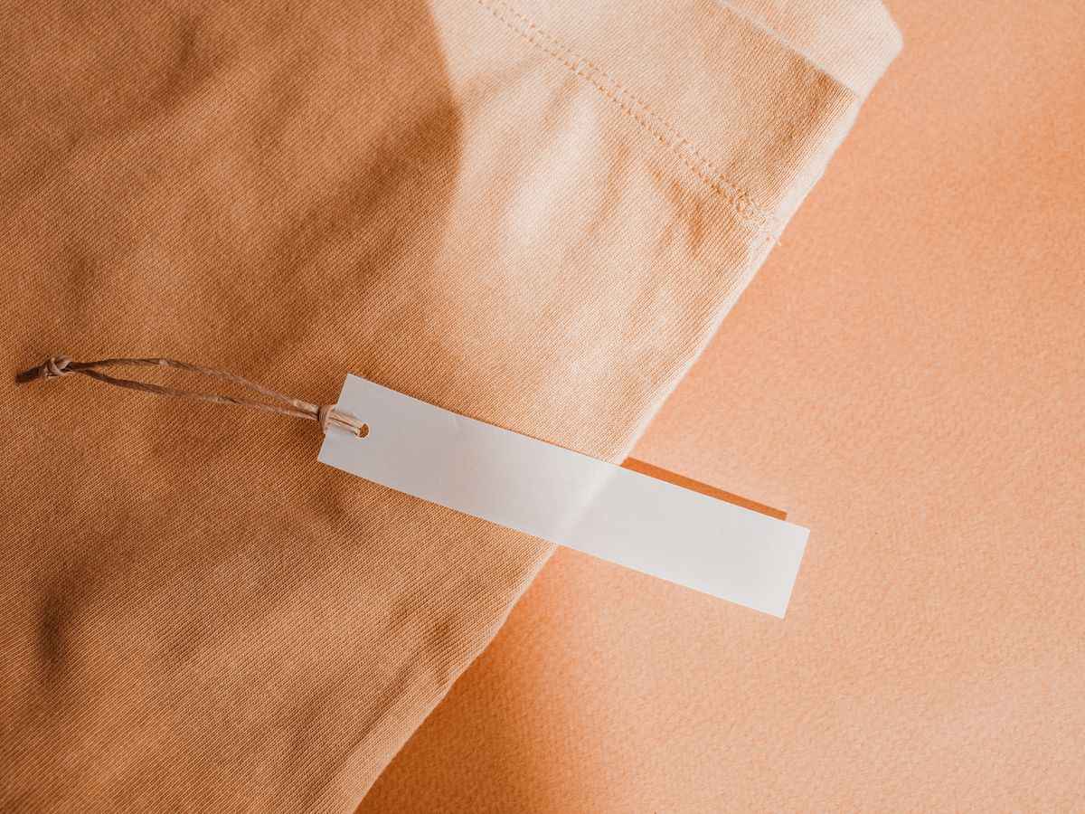 Beige fabric with a white care tag showing laundry symbols