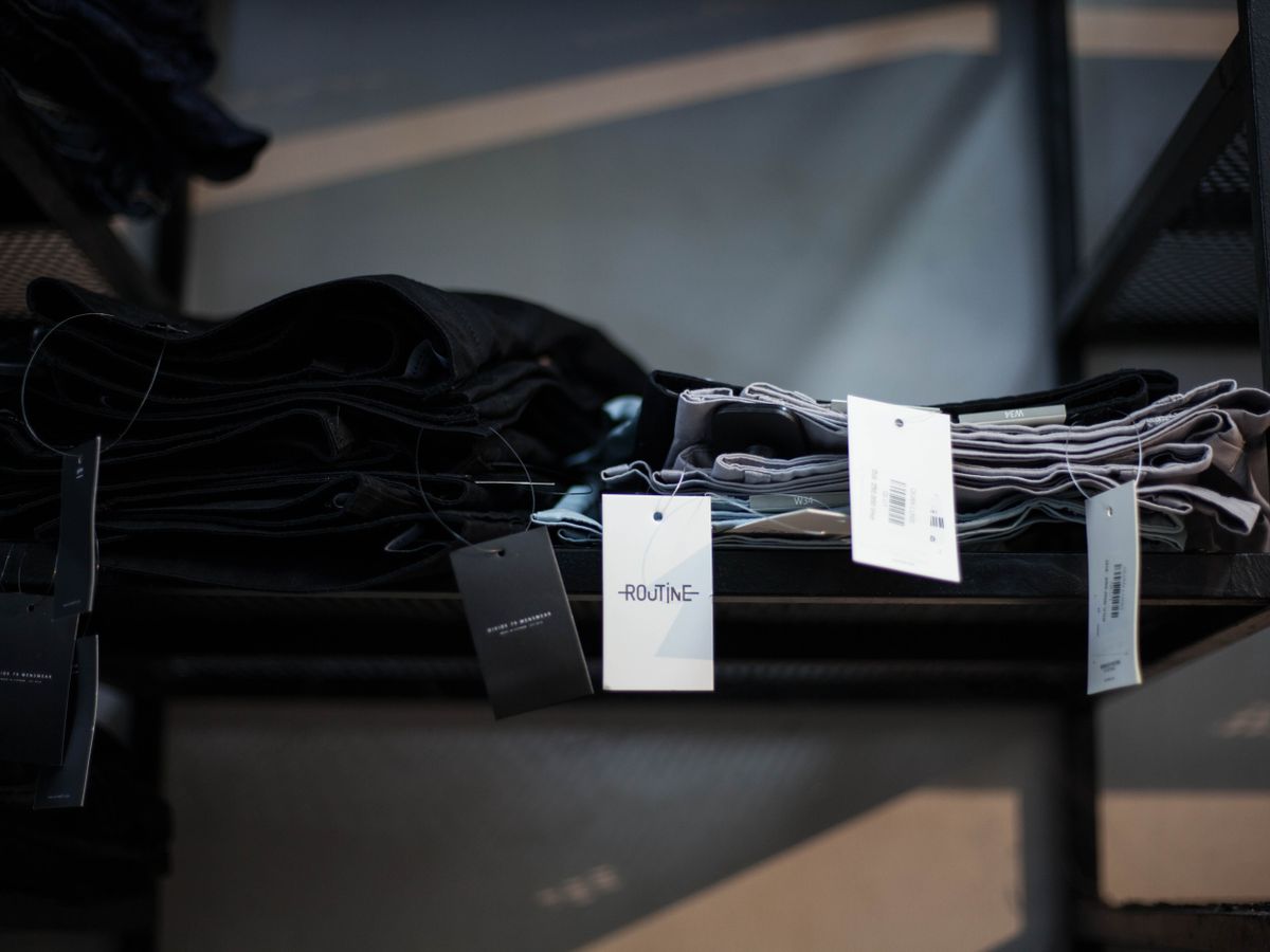 Dark garments folded on shelves to prevent fading