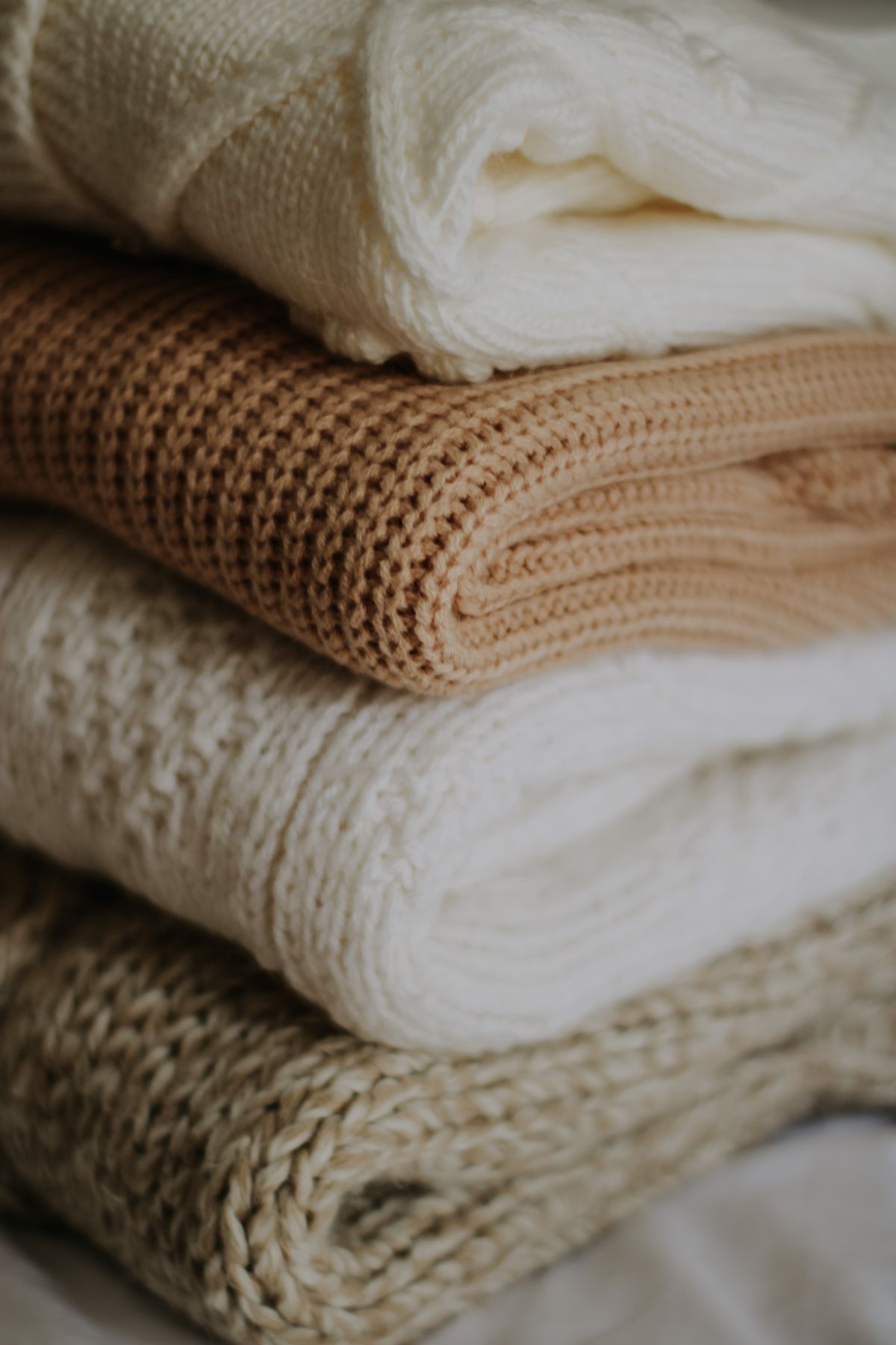 Close up of folded knitted clothes organized in a small space