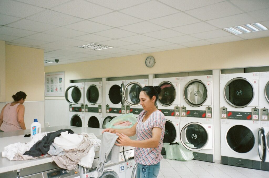 Person sorting laundry to treat grease and oil stains