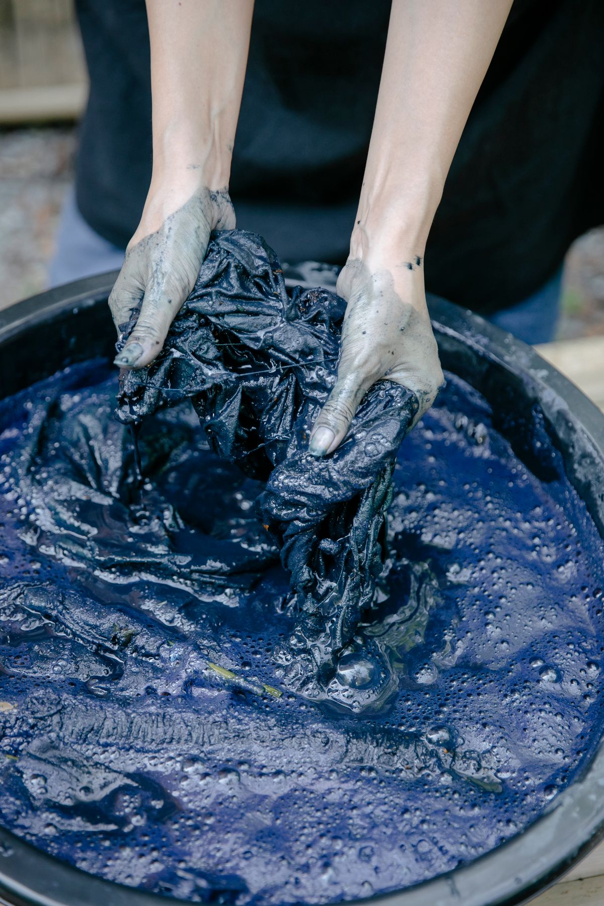 Close up of hand washing clothes in a bowl, laundry without a washing machine