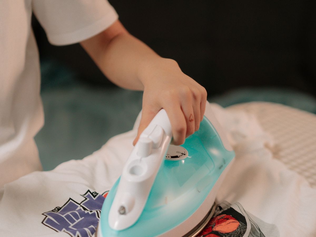 Ironing a shirt to make cheap clothes look expensive with a crisp finish