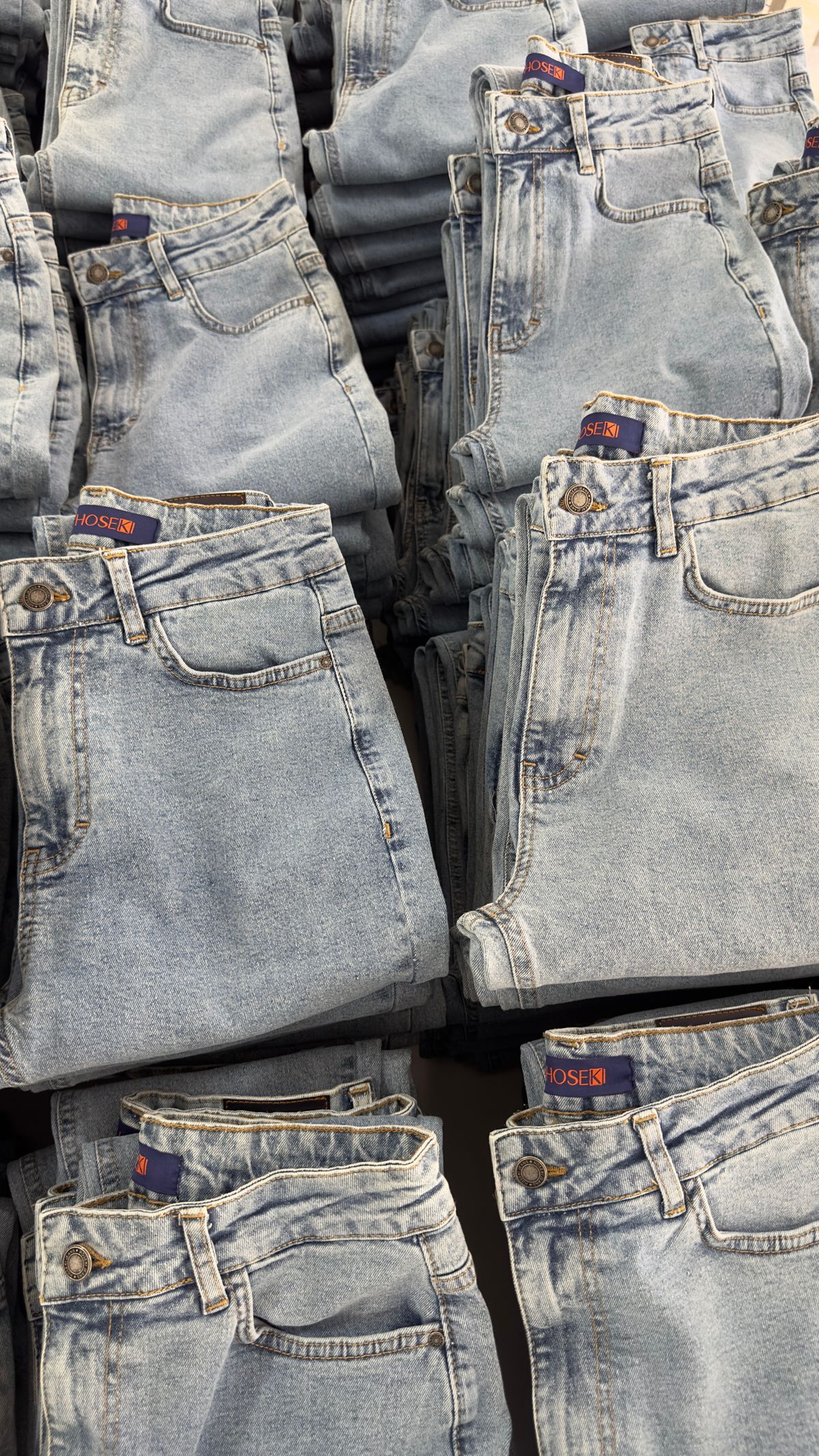 Pairs of jeans stored properly to care for denim over time