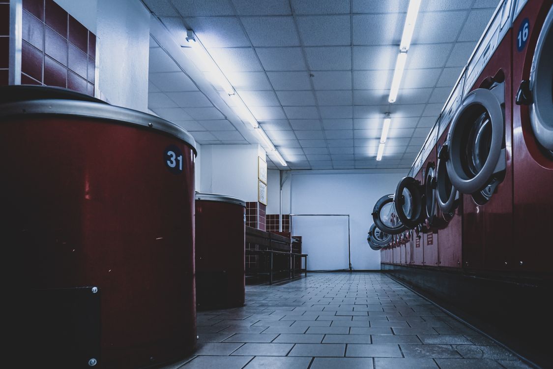 Bright laundromat interior with space to fold laundry