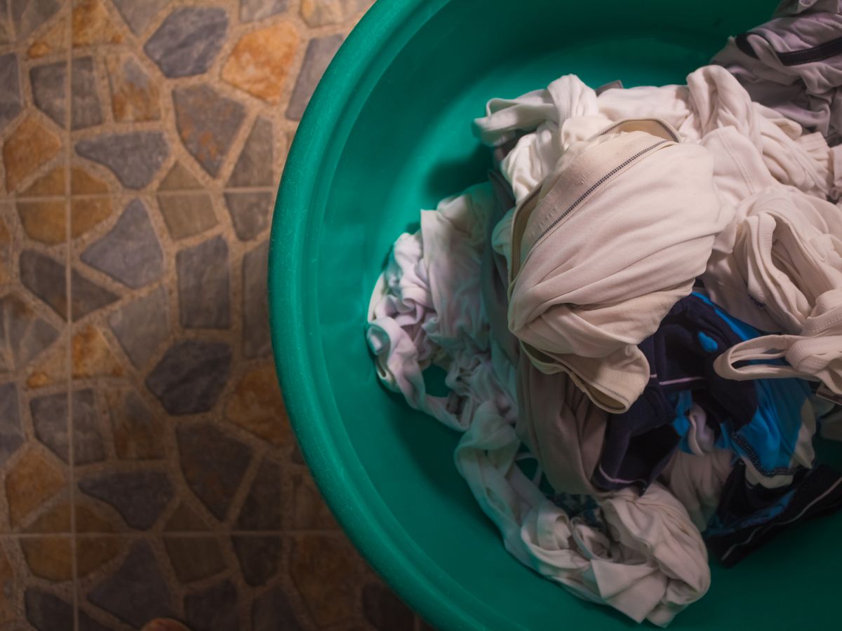 Doing laundry right by sorting clothes in a top-view laundry basket