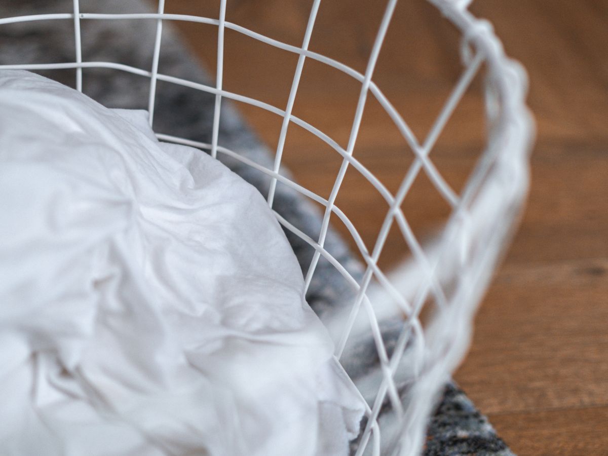White laundry basket with clothes ready for a single weekly wash day