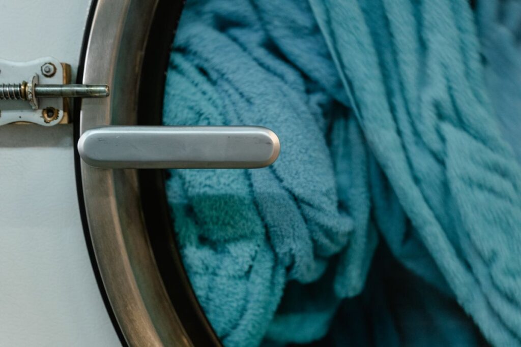 Front-loading washing machine door ready to machine wash hand wash only clothes