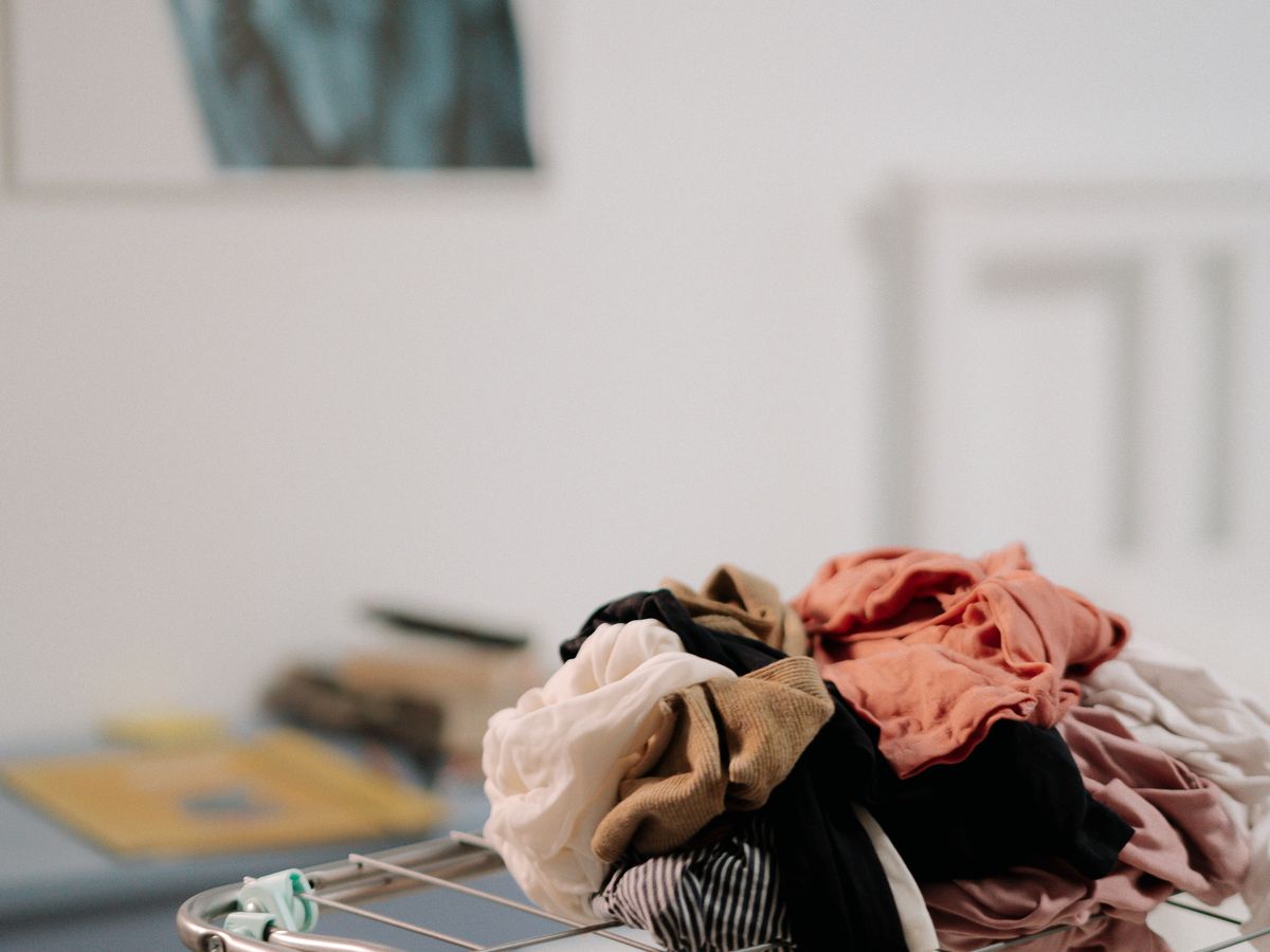 A metal drying rack small apartment setup holding clothes
