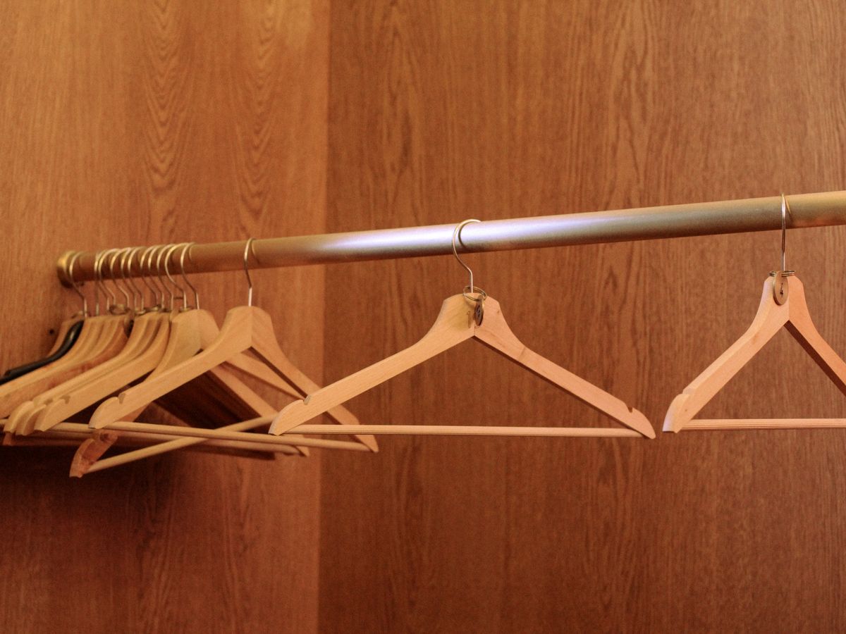 Organized closet with wooden hangers after decluttering