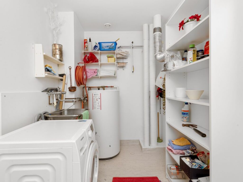 Organized laundry supplies on shelves in a small laundry room