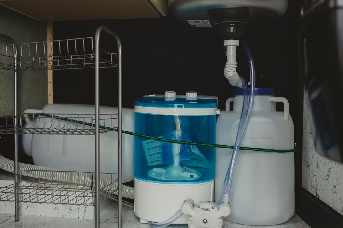 A compact portable washer stored in a small space