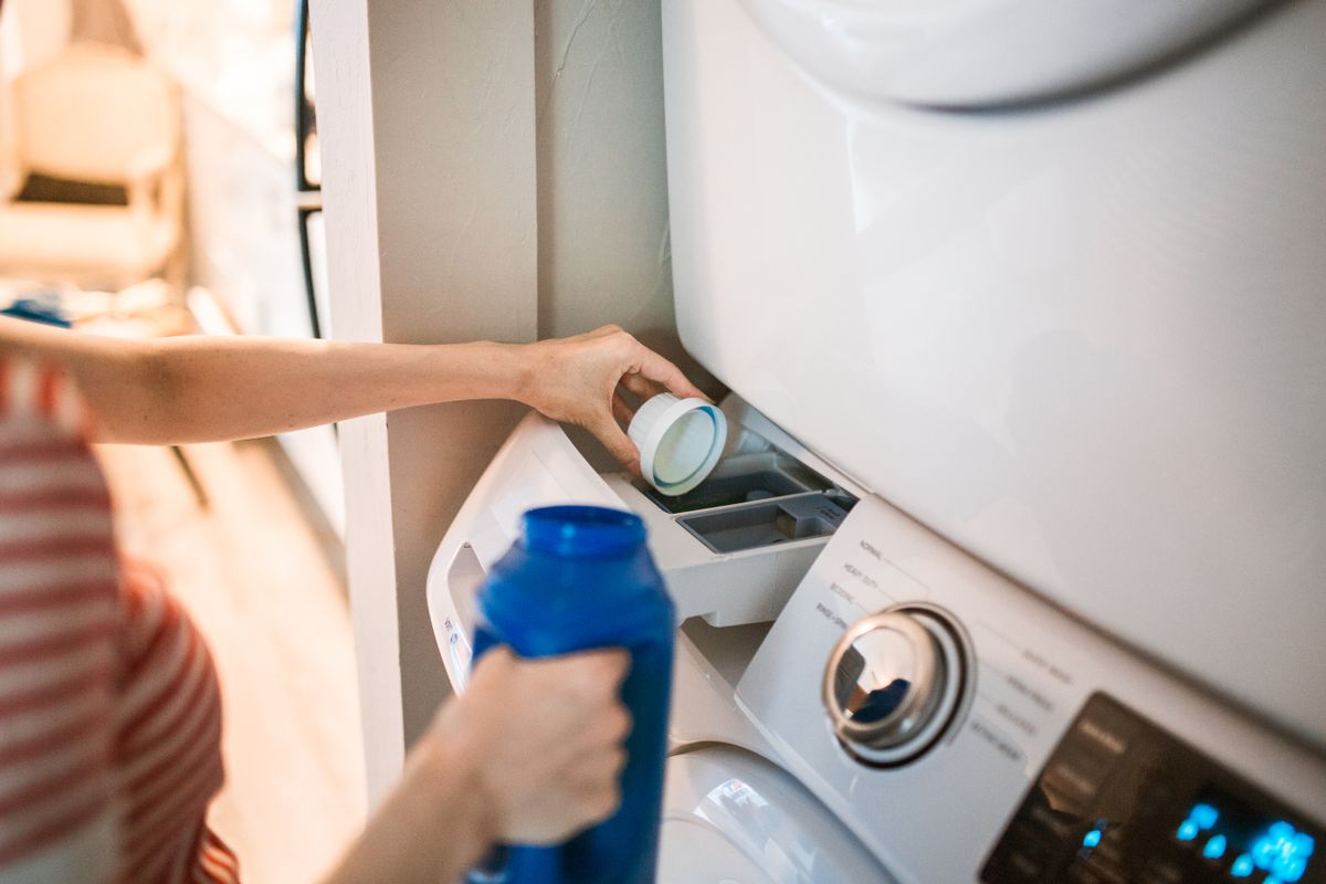 Pouring how much detergent one load needs into a washing machine