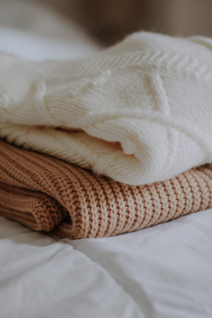 Stack of wool sweaters stored to protect stored clothes from moths