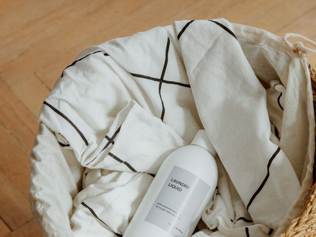 Laundry liquid in a woven basket ready for a realistic weekly laundry schedule