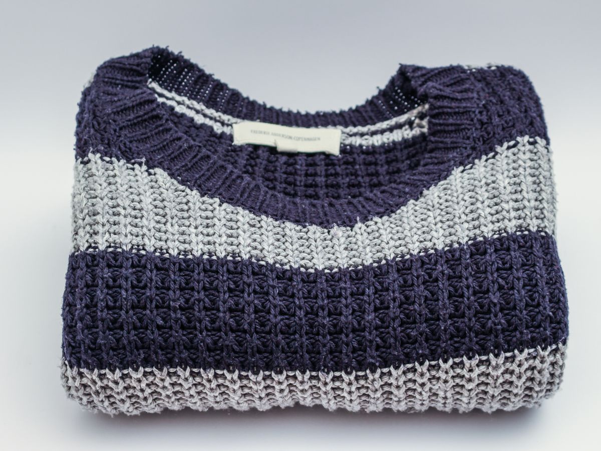 Knitted sweater laid flat to reshape and dry after unshrinking