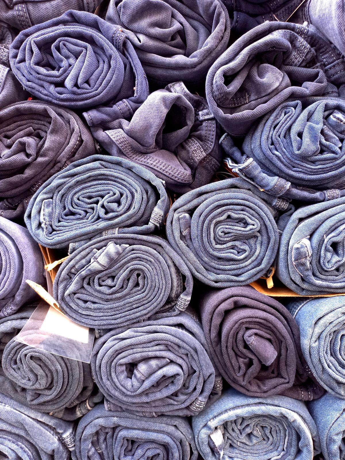Denim jeans rolled and stored upright to save drawer space