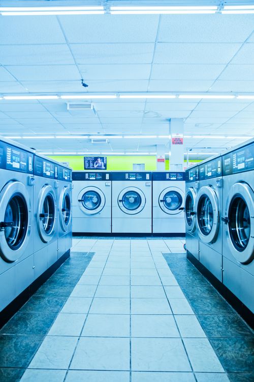 Row of laundromat washers used side by side to save time