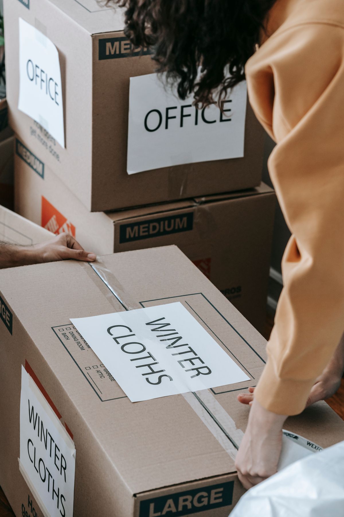 Sealing a box to store off-season clothes for the winter