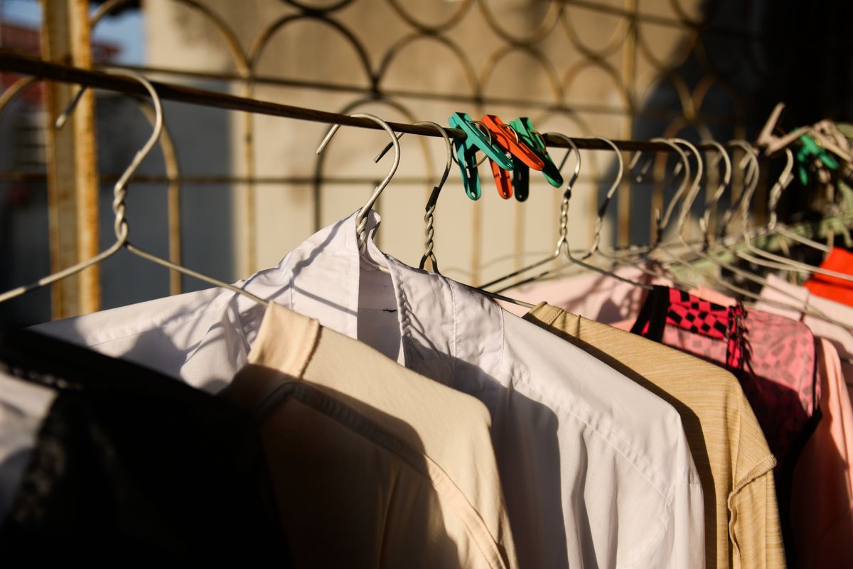 Clothes drying on a compact rack in a small laundry space