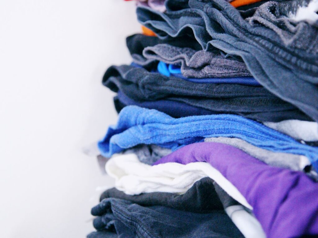 Neatly sorted clothes separated into color piles for doing laundry right