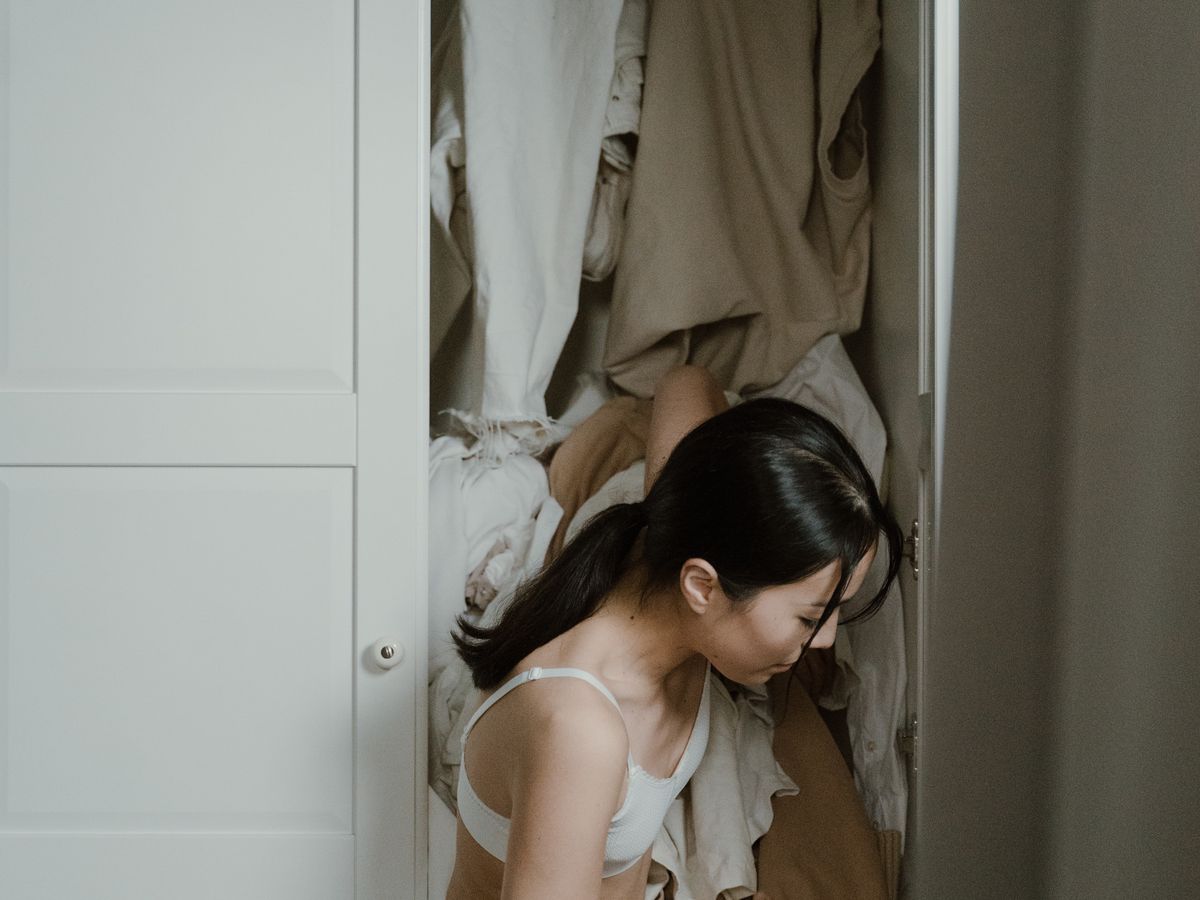 Closet declutter in progress sorting an overflowing wardrobe