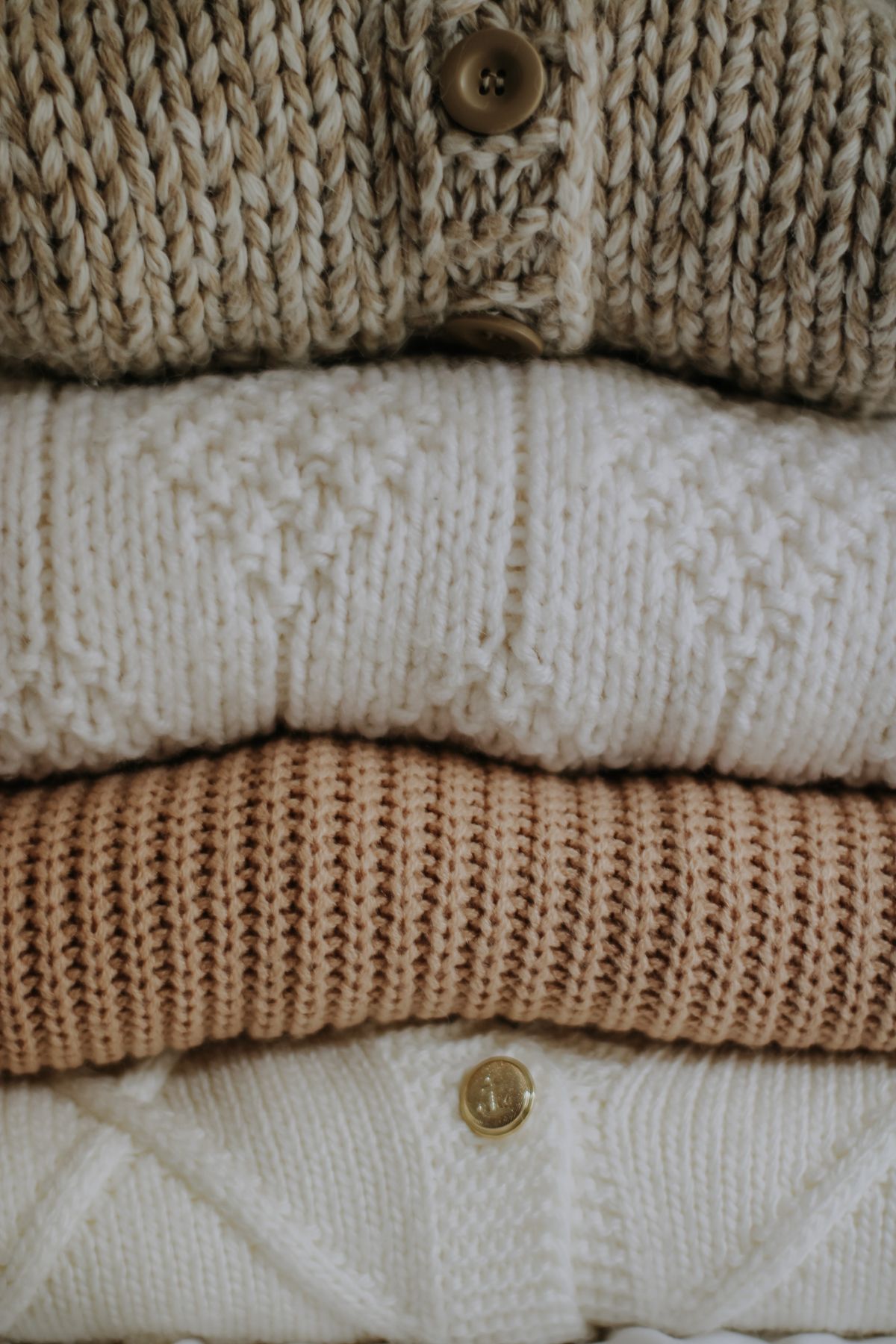 Stacked neutral knit sweaters cared for and free of pills