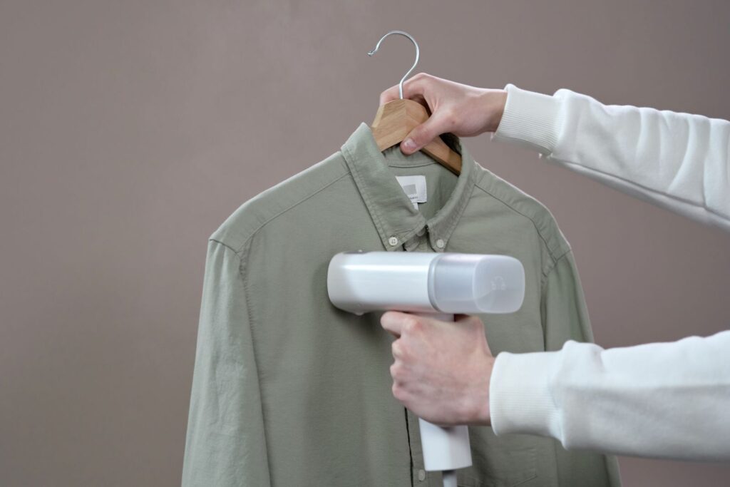Steamer vs iron comparison: steaming a shirt with a portable steamer