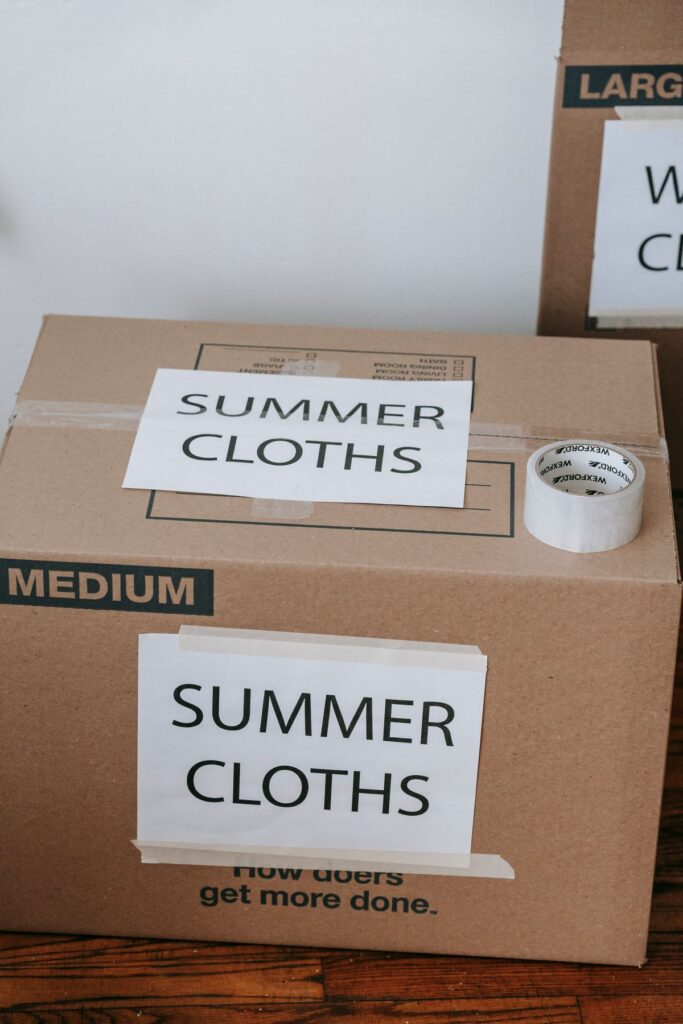 Labeled box used to store off-season clothes in a small apartment