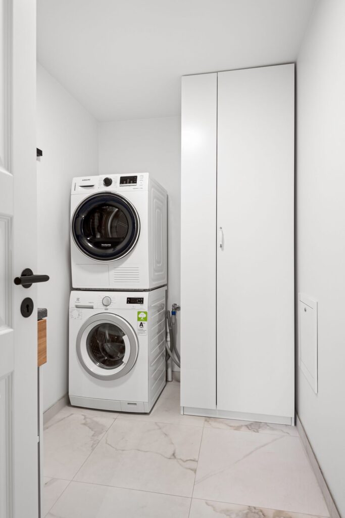 Tiny laundry closet with a stacked washer and dryer