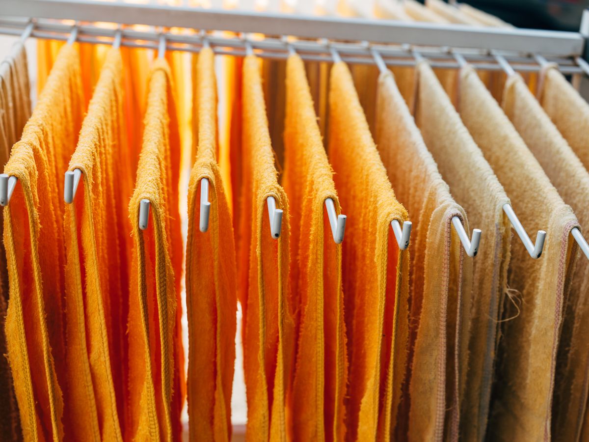 Towels hanging on a compact drying rack to manage airflow