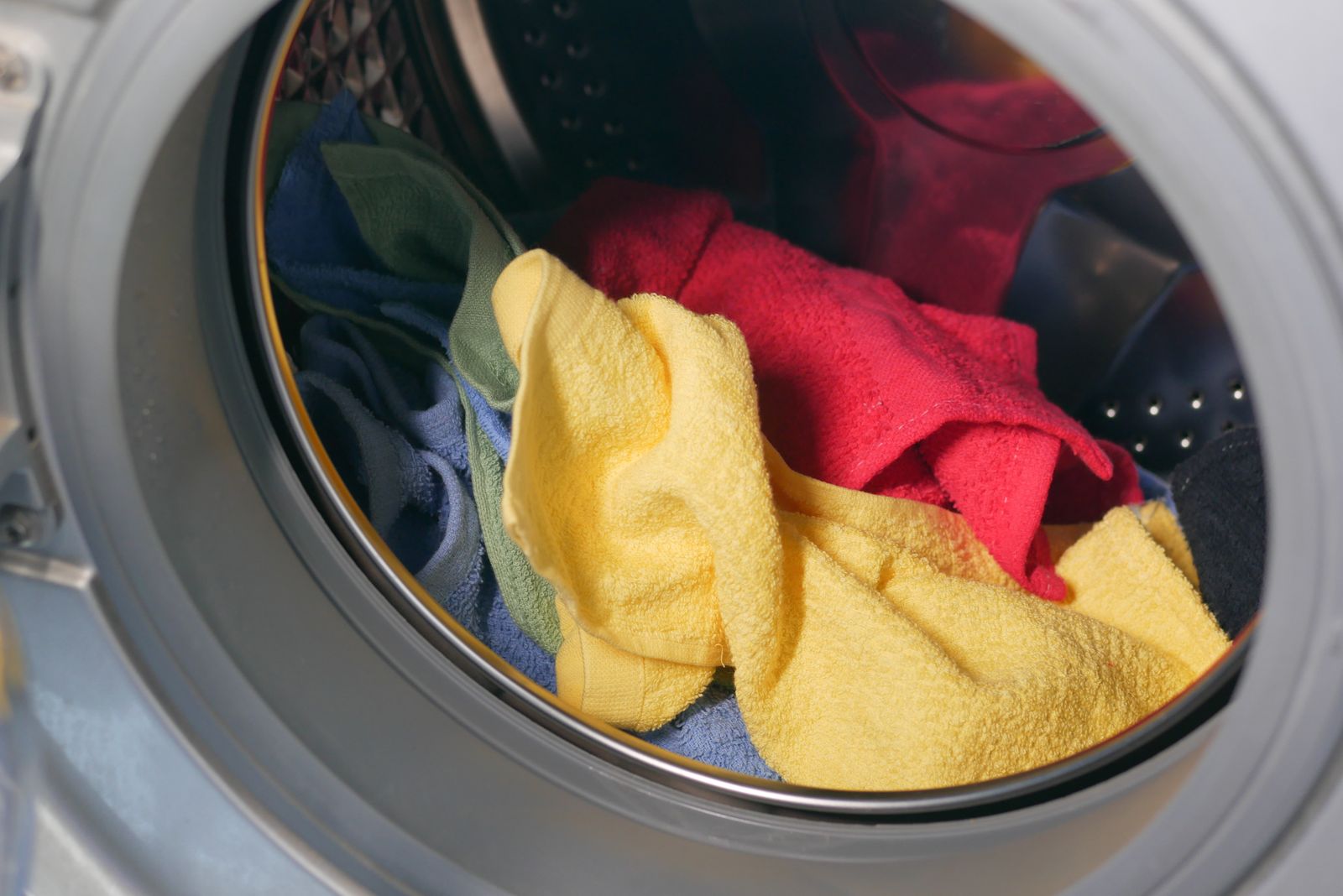 Fresh clean laundry inside a washing machine that no longer smells