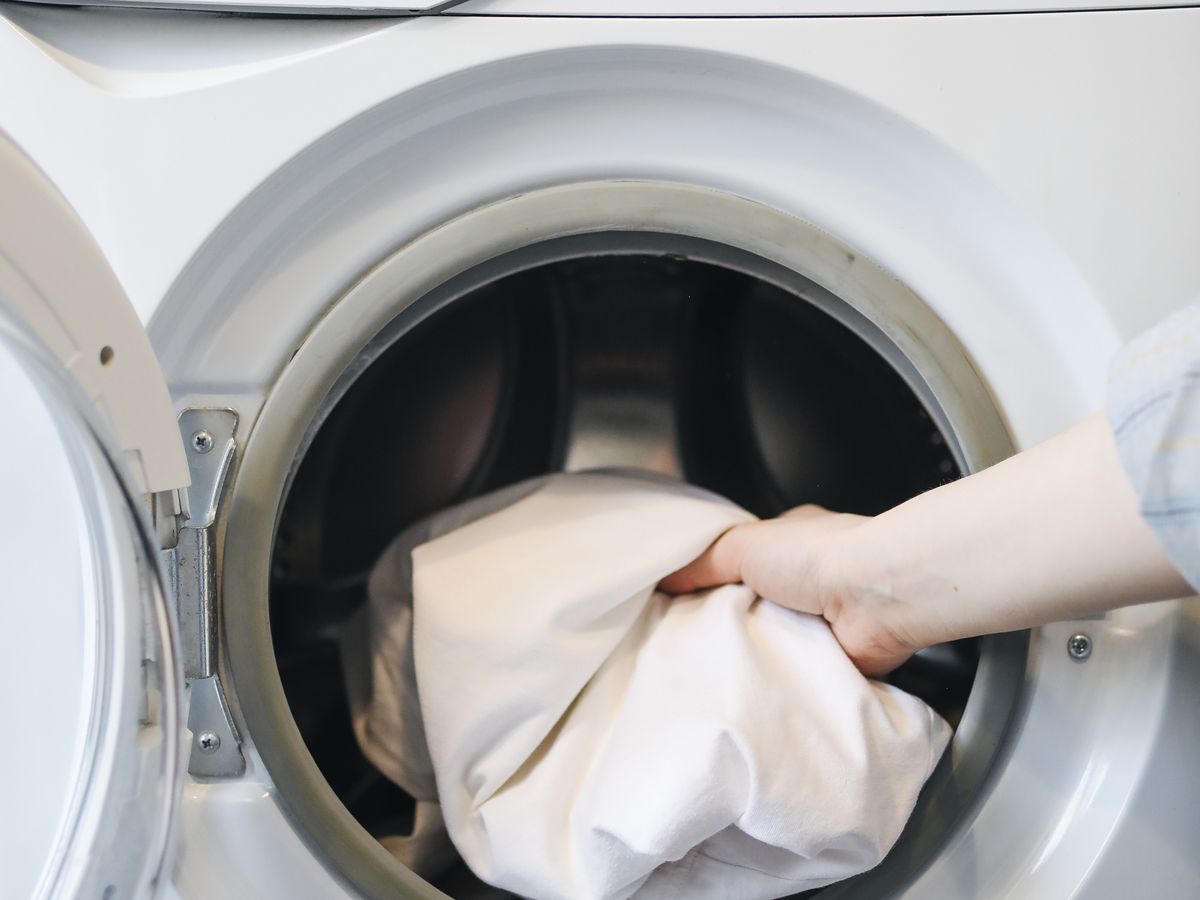 Loading stained clothes into a front-loading washing machine