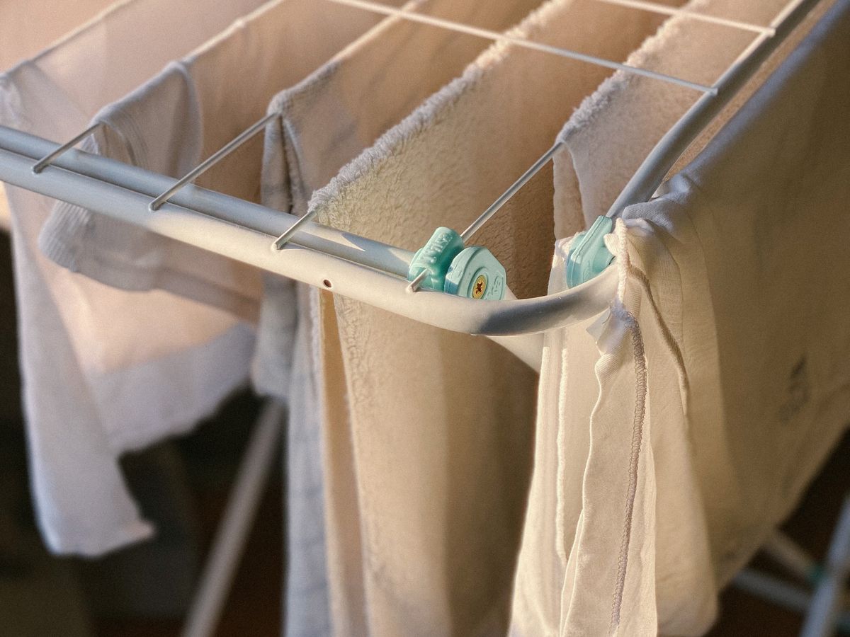 White clothes air drying on a rack in a small apartment