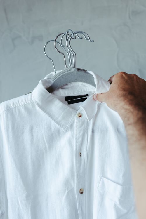 White shirt on a hanger free of sweat stains and yellowing