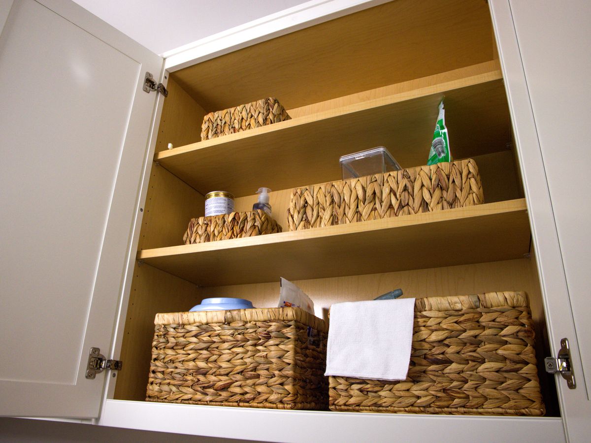 Wicker baskets used for tidy shelf storage of laundry and household items